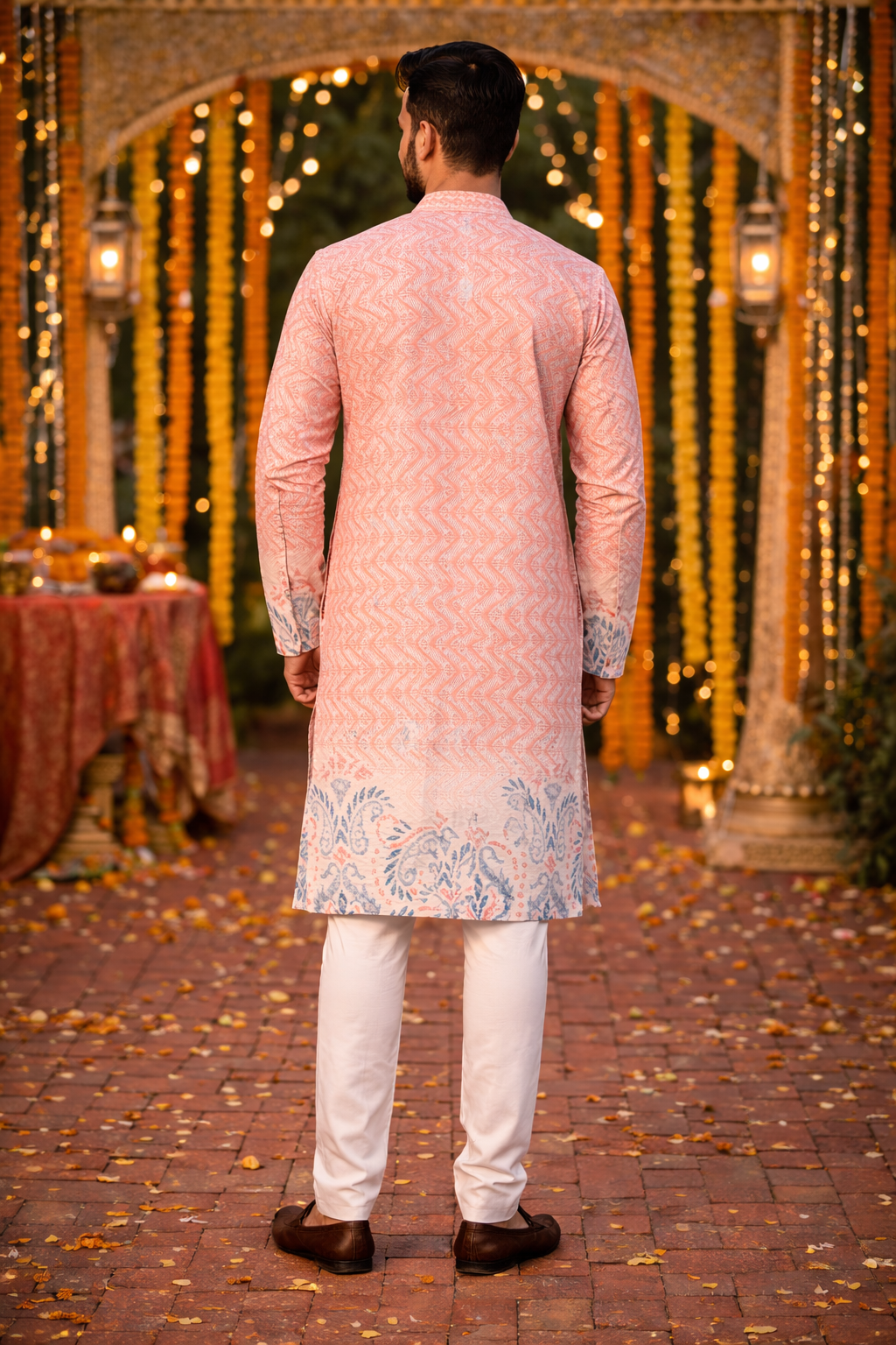 Back view of men's peach printed kurta set with traditional Indian pattern and white pajama.