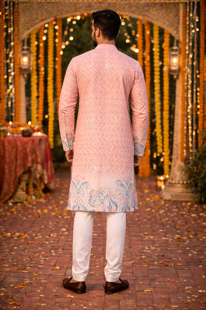 Back view of men's peach printed kurta set with traditional Indian pattern and white pajama.